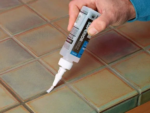 Applying sealer along tile grout lines